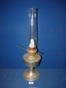 An Aladdin metal oil lamp with clear chimney, 23" tall.