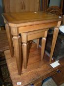 A Nest of Two Satinwood and other woods Occasional Tables standing on tapering square legs,