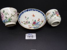 Two Qianlong period coffee cans painted flowers and a famille rose saucer of similar date painted