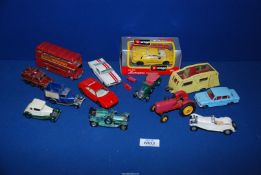 A yellow Dinky Caravan, a Corgi red bus, a red Dinky tractor,