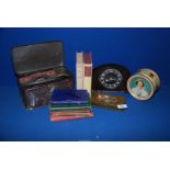 A quantity of miscellanea including Smith's Bakelite mantle clock, commemorative tins, books,