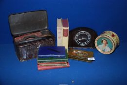 A quantity of miscellanea including Smith's Bakelite mantle clock, commemorative tins, books,