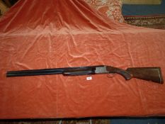 A 12 bore double barrelled over and under selective ejector,