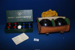 A cased pair of bowls, 'AG nos. 1 and 2' and a boxed set of mini carpet bowls.