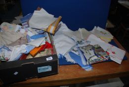 A quantity of linen table cloths, napkins and some embroidery, etc.