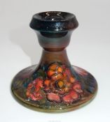 A Moorcroft dumpy Candlestick decorated with anemones, 3 1/2" tall.