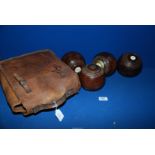 Four Taylors-Rolph Penshurst wooden lawn Bowls, in leather case.