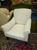 A cream upholstered low easy Armchair standing on tapering square front legs and complete with a