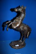A cast metal figure of a rearing horse , label to base 'East Java bronze cast over Clay, Singapore',