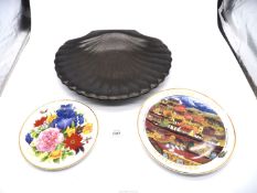 A large black china shell shape dish and two display plates.