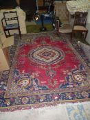 A floral pattern polychrome carpet, some wear 121'' x 85''.
