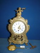 An ornate brass cased Mantel clock of French design,