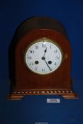 A dome topped Mahogany cased mantle clock having a French two-train movement striking on a coiled