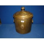 A brass coal bin, on bun feet, 17" tall.