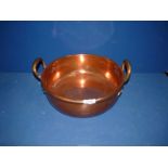 A flat bottom, two handle copper pan, 13 1/2" diameter.