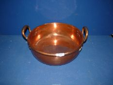 A flat bottom, two handle copper pan, 13 1/2" diameter.