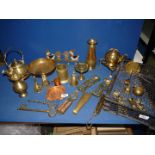 A quantity of brass including bells, vases, coat hook, nutcracker, sadler's weight,