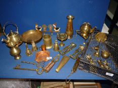 A quantity of brass including bells, vases, coat hook, nutcracker, sadler's weight,