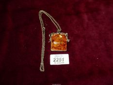 A handmade amber coloured Pendant with chain.