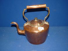 A copper Kettle with brass finial.