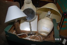 A quantity of table lamps and a mirror.