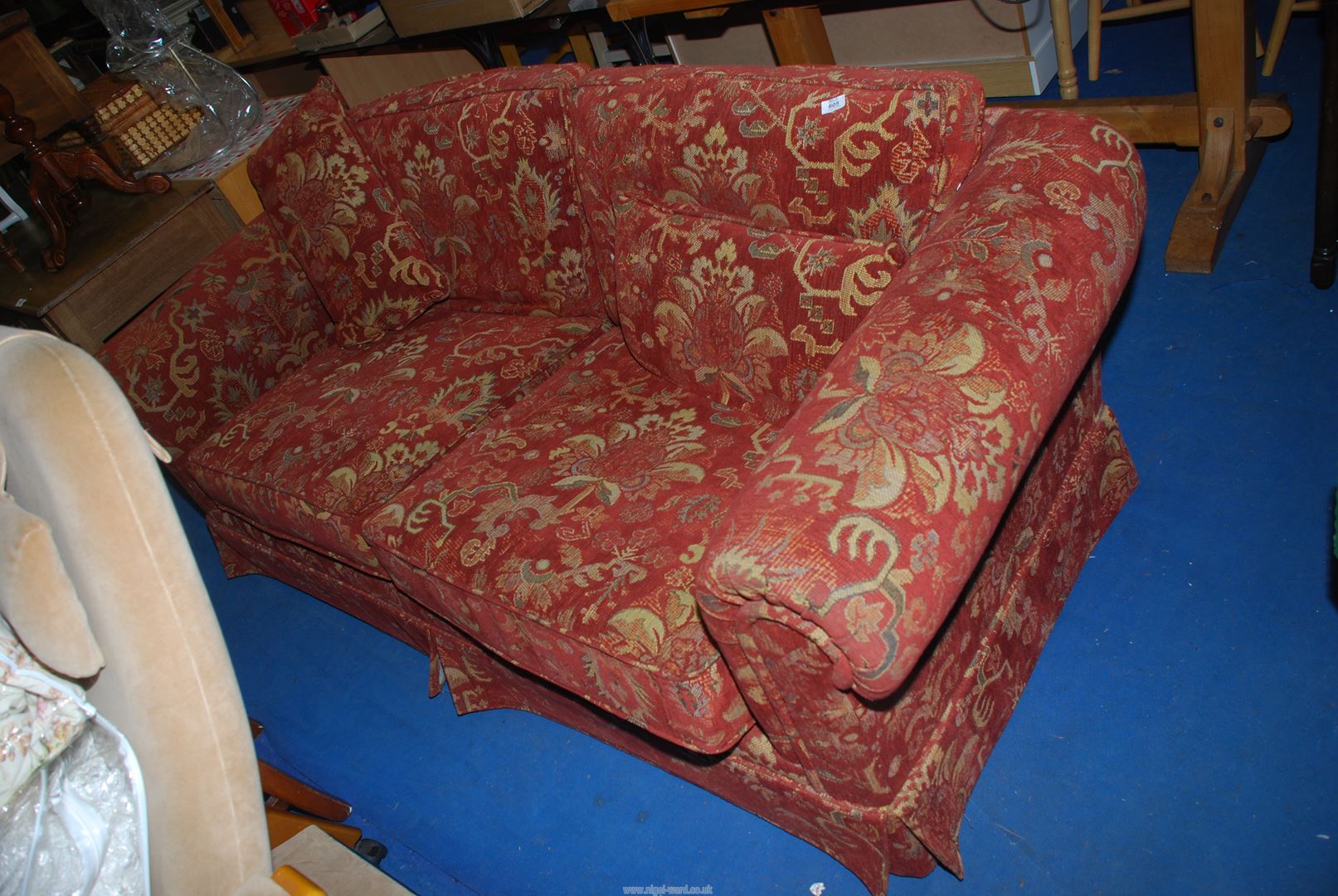 A two seater red ground sofa, 80" long x 3' deep x 31" high.