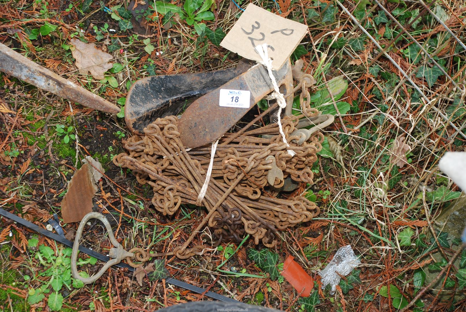 A shoe last and an antique surveyor's measuring chain.