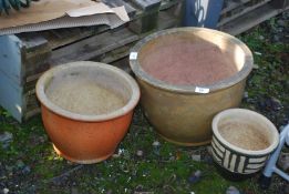 Three glazed pots.