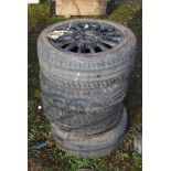 Four black aluminium wheels and tyres: 195/50R15, 4 stud fixing, tyres in fair condition,