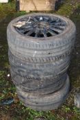 Four black aluminium wheels and tyres: 195/50R15, 4 stud fixing, tyres in fair condition,