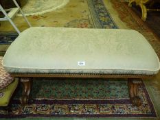 An elegant Walnut and other woods low upholstered Stool standing on scroll terminating end supports