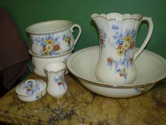 A Falconware bedroom set in floral pattern comprising wash jug and bowl, two chamber pots,