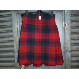 A hand made heavy Tartan Kilt in red, navy and green with leather strap, well worn.