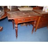An Edwardian Mahogany side table having a formerly inset leather top,