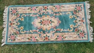 A sage green ground tientsin Chinese rug, central medallion and floral borders, a/f., approx.