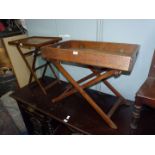 An Oak Butler's Tray having fold down sides with brass fittings and raised on a folding stand,