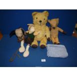 A box of toys including teddy bears, dog on wheels, rabbit, etc.