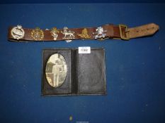 A leather belt with Military Cap Badges pinned to it, to include, The Royal Scots Greys,