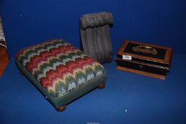 A small footstool with tapestry top and bun feet, vintage money tin and a black stone,