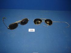 Two pairs of Pilot Aviator sunglasses.