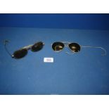 Two pairs of Pilot Aviator sunglasses.