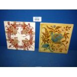 Two decorative Tiles, brown and cream floral wreath and blue and pink floral.