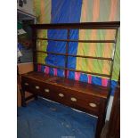 An Oak Welsh Dresser having three frieze drawers with oval brass back plate handles and complete