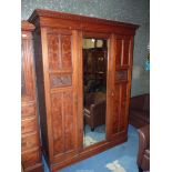 A Walnut & Mahogany wardrobe having a dentil frieze,