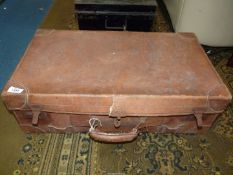 A leather suitcase with blue interior lining containing mostly classical records,