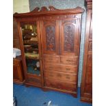 A Walnut & Mahogany wardrobe with carved details, the drawer fronts with floriate details,