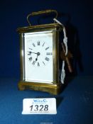 A Brass Carriage Clock, the balance wheel visible through a bevelled glass window to the top,