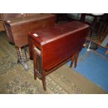 A Mahogany swing-leg Sutherland Table standing on shaped square legs,
