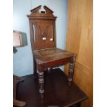 An Edwardian Mahogany Hall Chair having a solid wood seat, turned legs,