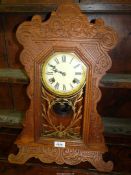 A "Gingerbread" style wall Clock, the glazed door panel with gold floral relief, by Felix,